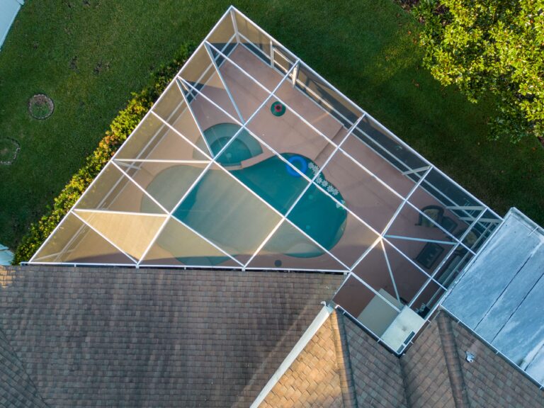 Aerial view of pool screen enclosure surrounded by trees